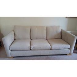 Large beige sofa with matching chair