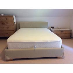 Double bed with fabric padded covered wooden frame