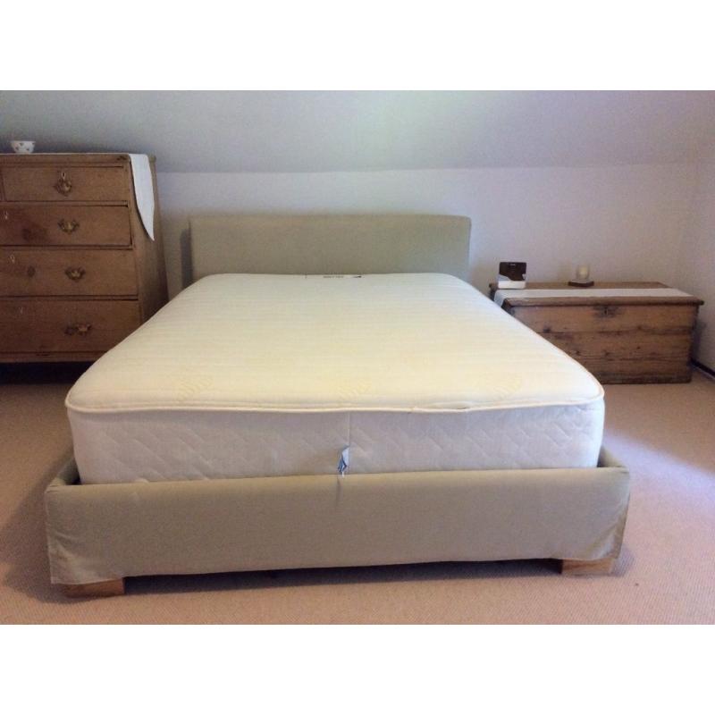 Double bed with fabric padded covered wooden frame