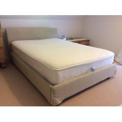 Double bed with fabric padded covered wooden frame