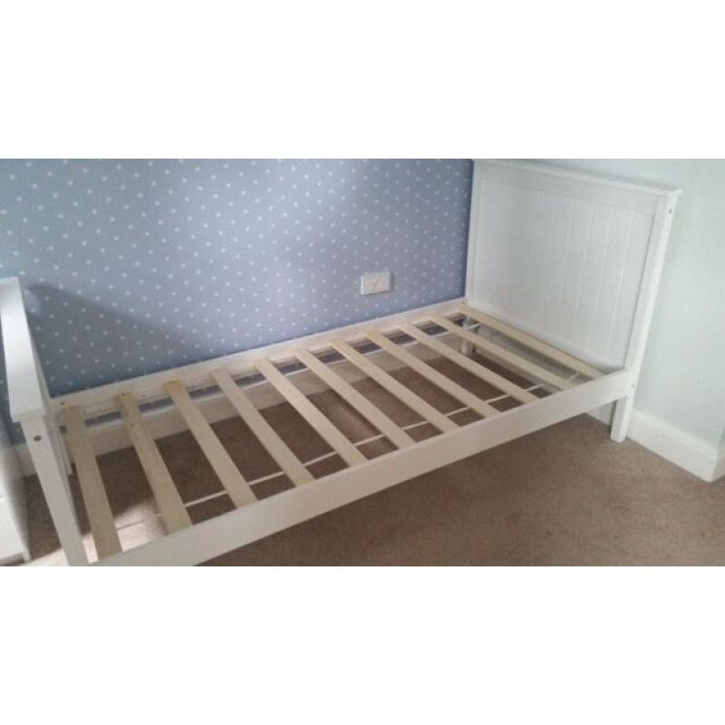 Single white wooden bed, slatted base