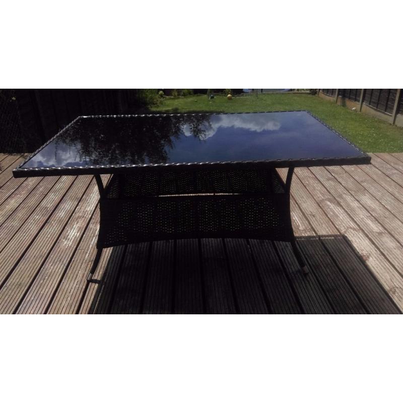 Stylish Glass and Wicker Patio Table. Tinted Glass. With cover. Used but table in great condition