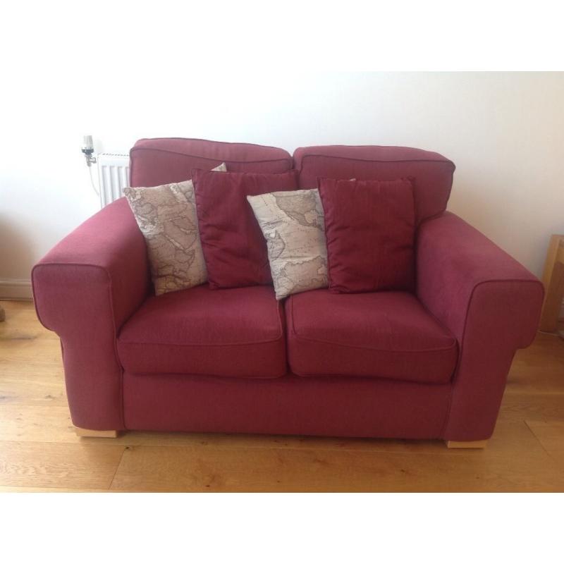 Small two seater burgundy sofa