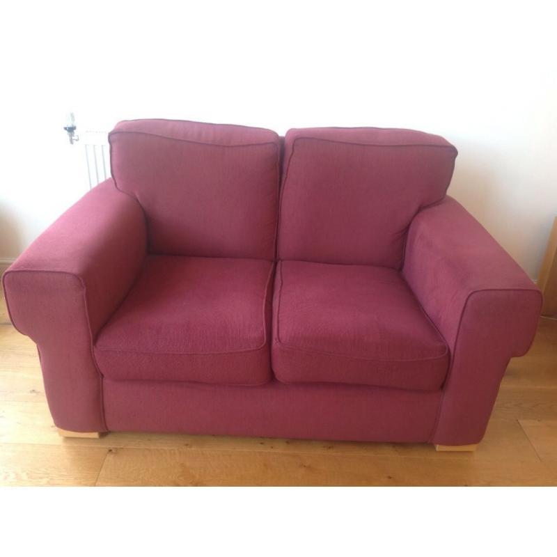 Small two seater burgundy sofa