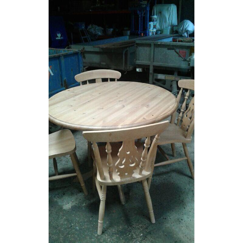 Pine table circular, no chairs.