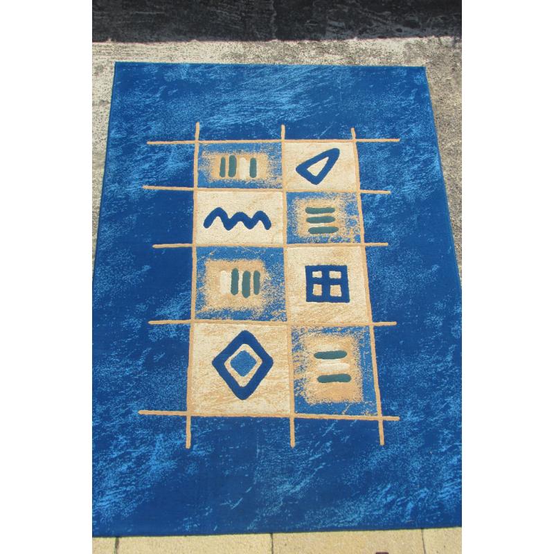 LARGE BLUE RUG. 91" IN LENGTH AND 68" WIDE.